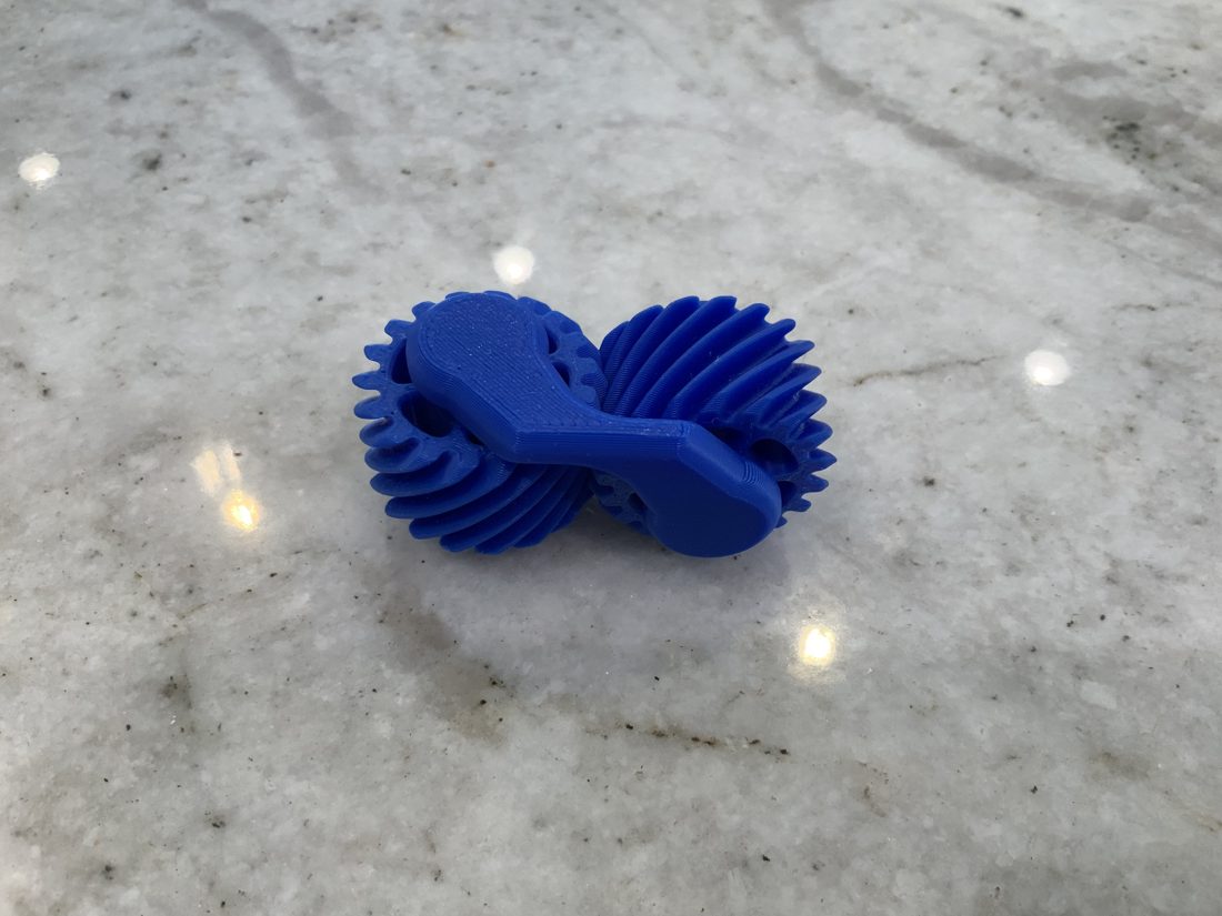 Helical gear fidget with meshing gears